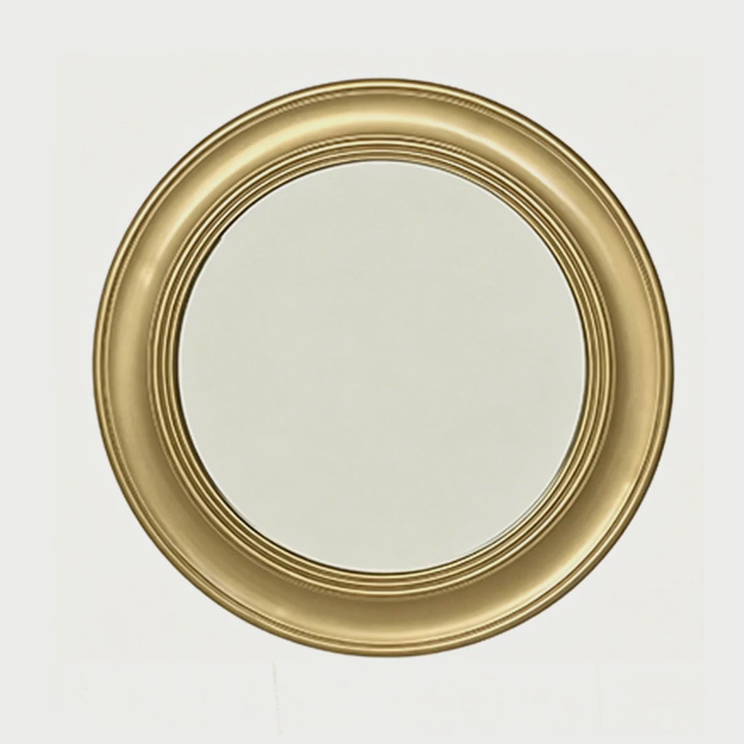 Slow cinematic tour of the brushed gold round wall mirror from real product photography