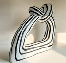 Handmade black-and-white striped ceramic knot sculpture