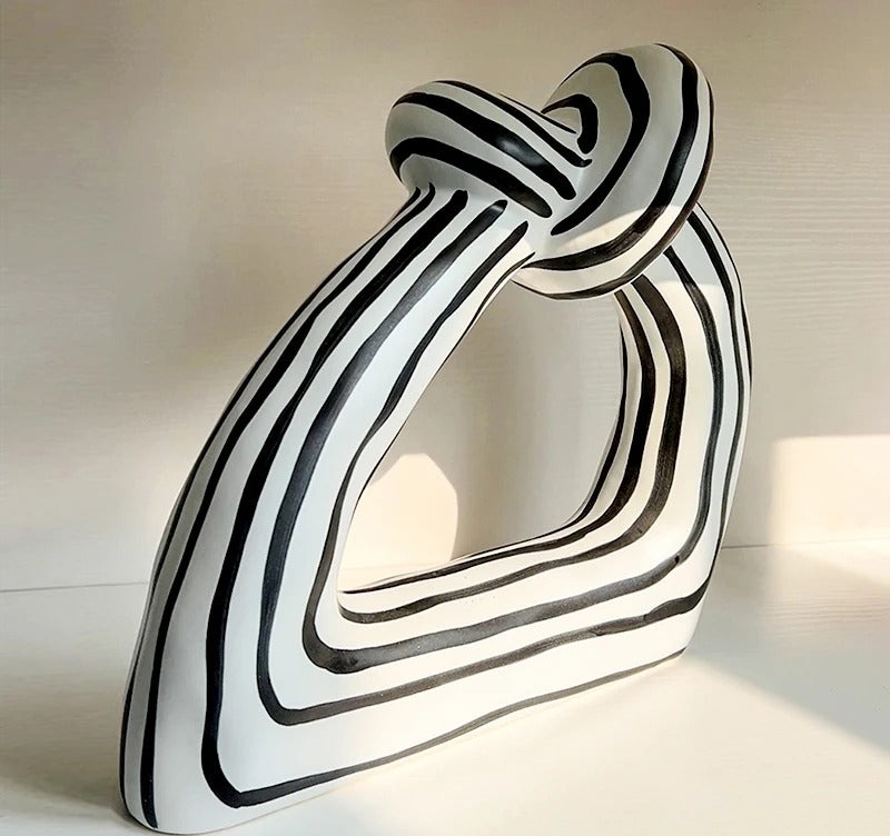 Handmade black-and-white striped ceramic knot sculpture